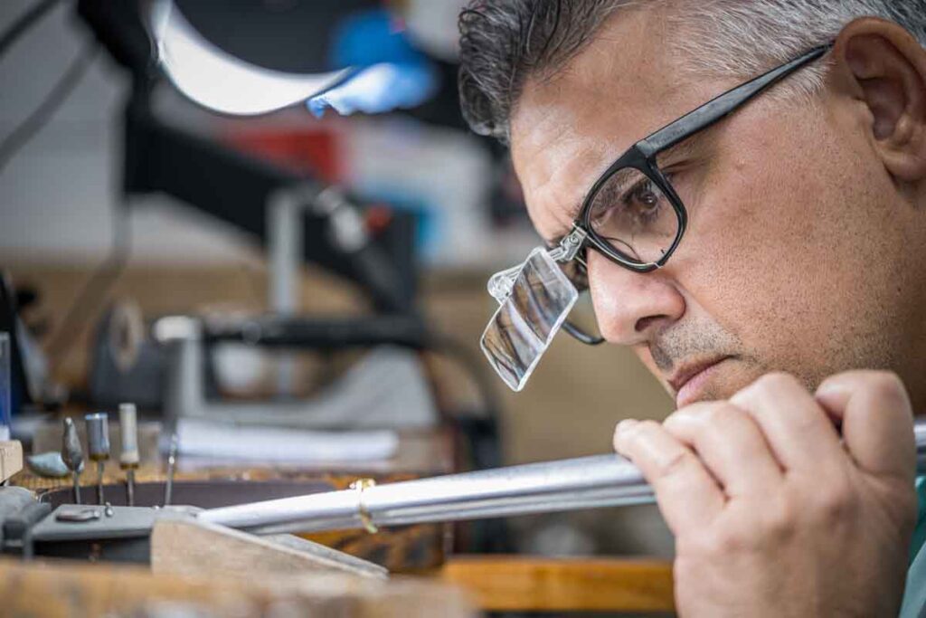 Jeweler looking closely at ring's new size.