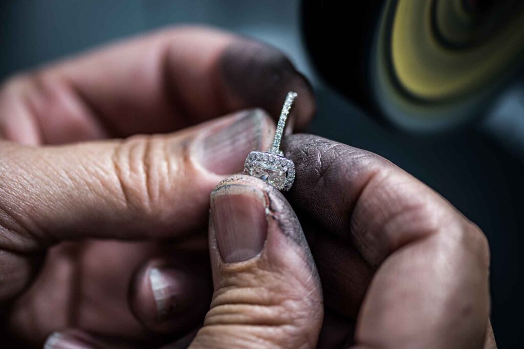 Jewelry technician holding a piece of diamond ring.