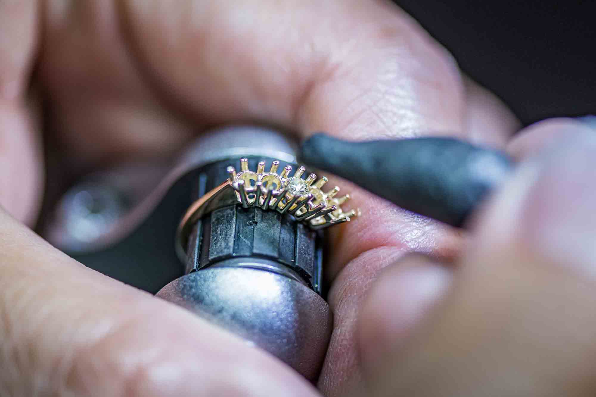 Jewelry Technician places the diamond on the ring.