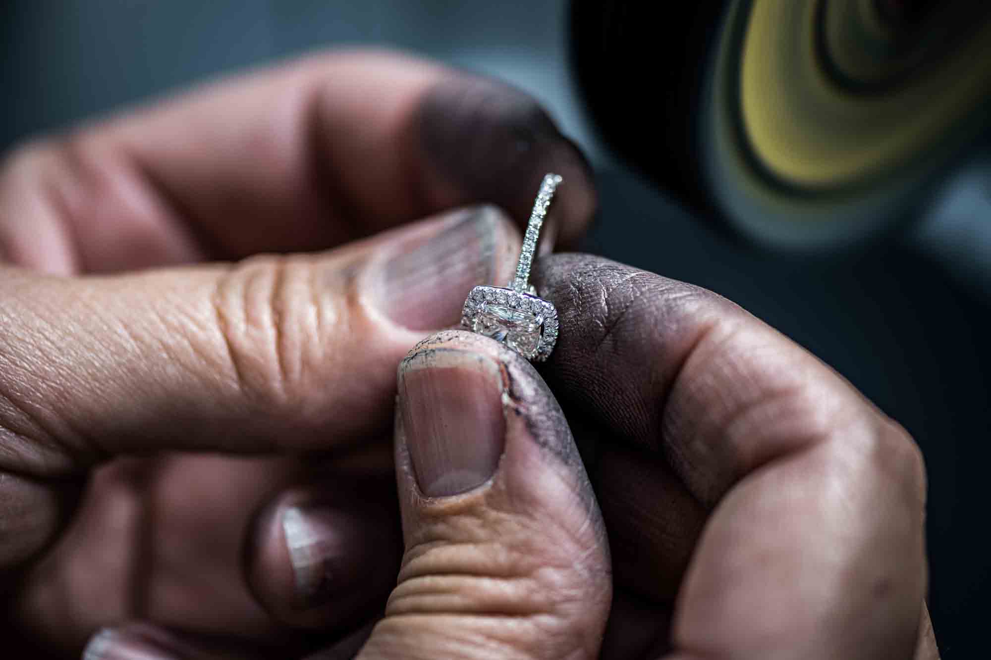 Jewelry technician holding a piece of diamond ring.