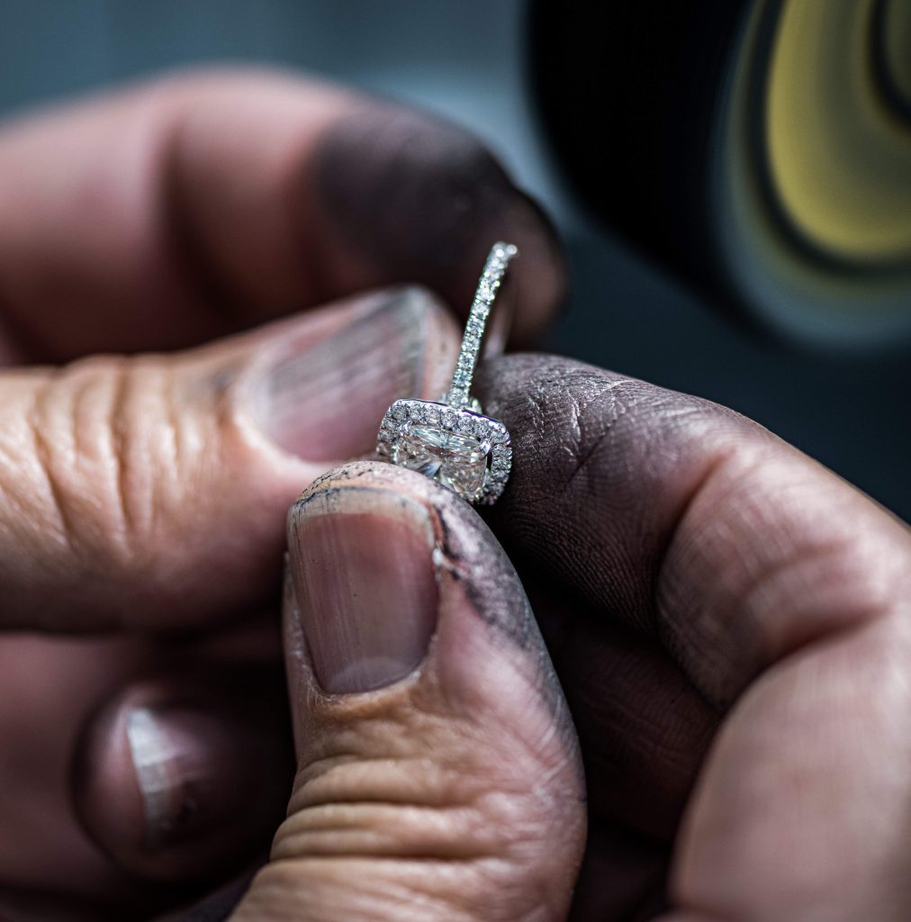 Jewelry technician holding a piece of diamond ring.